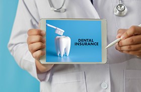 Medical professional holding tablet with dental insurance information