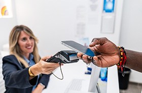 Dental team member accepting payment from patient