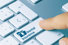 Finger pressing “dental insurance” key on keyboard