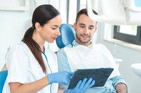 Dentist and patient discussing dental implant salvage treatment
