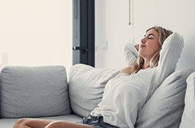 Woman resting comfortably on sofa at home